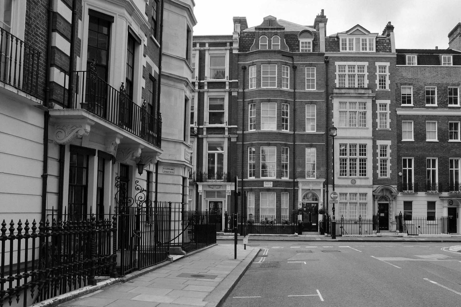 pexels-yelenaodintsova-4655752 Street view of classic London townhouses with ornate balconies and brick facades.